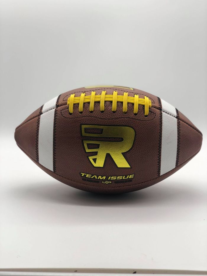Leather american game ball with gold R logo and yellow lace in photobooth